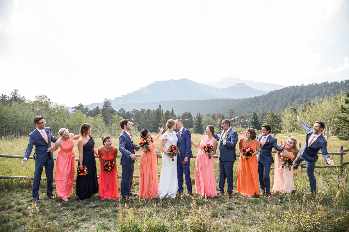 bride and groom party with coral colored dresses
