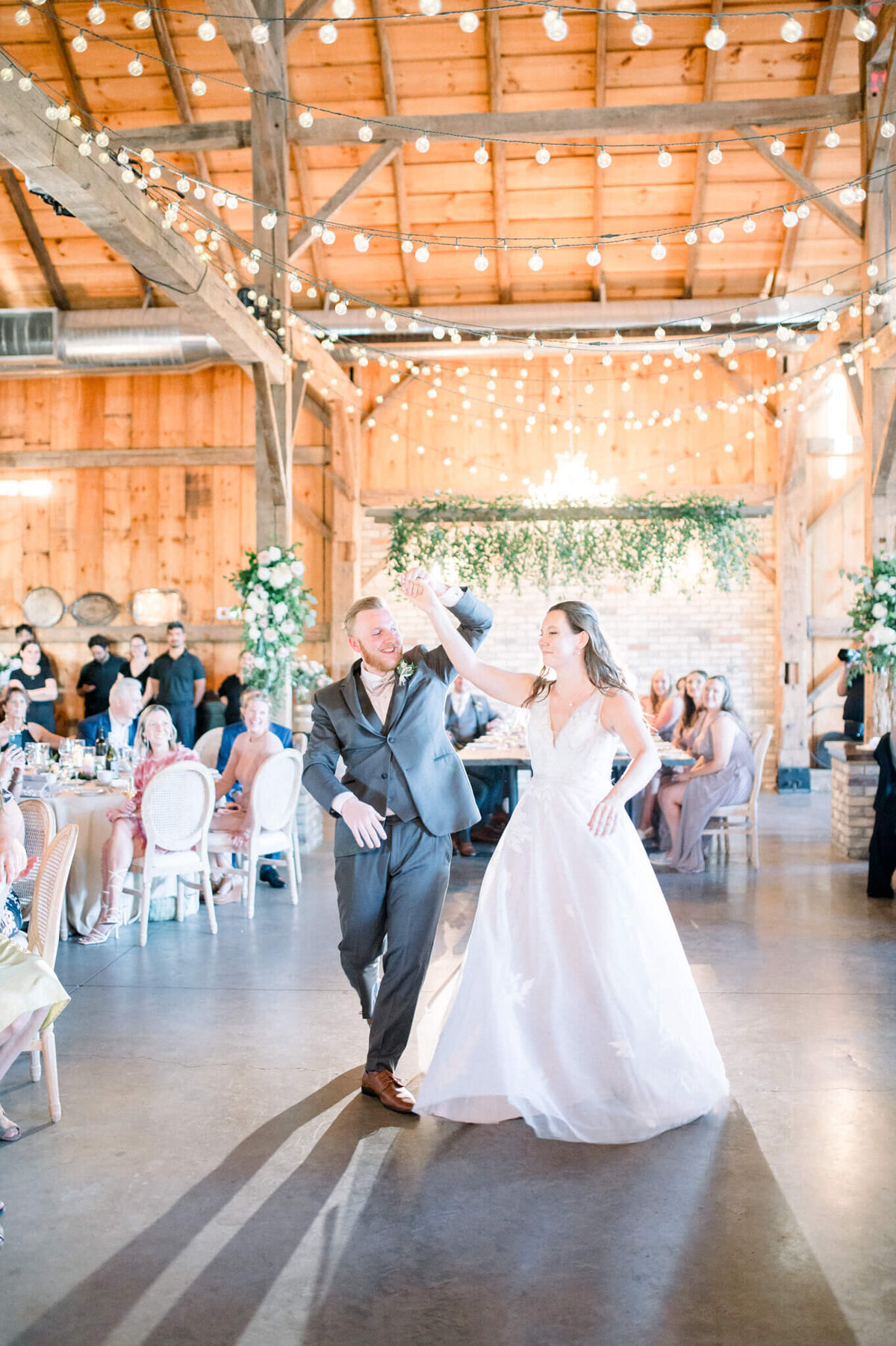 Bride and groom enter the barn to their reception