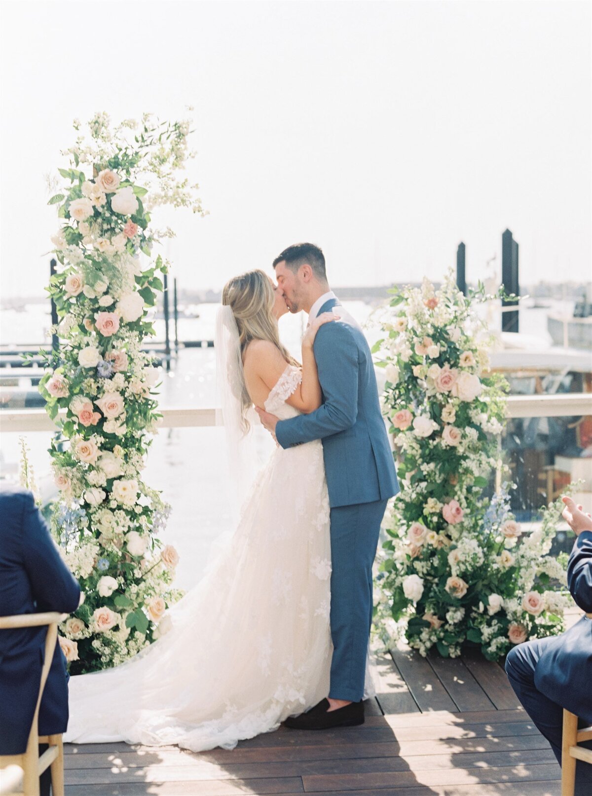 Kate-Murtaugh-Events-wedding-planner-Newport-ceremony-floral-arch-boat-dock-harbor-first-kiss
