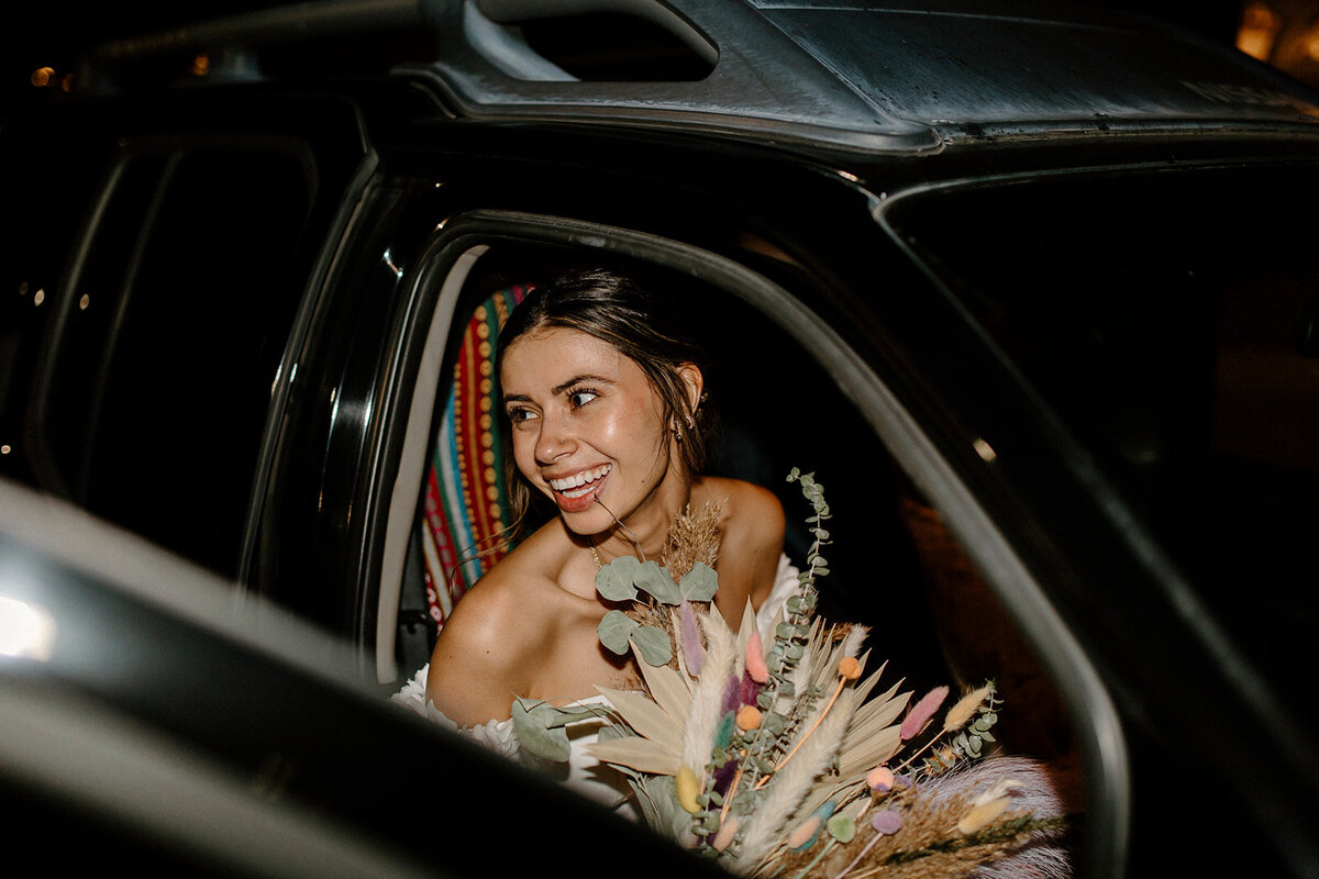 bride smiling in a limousine