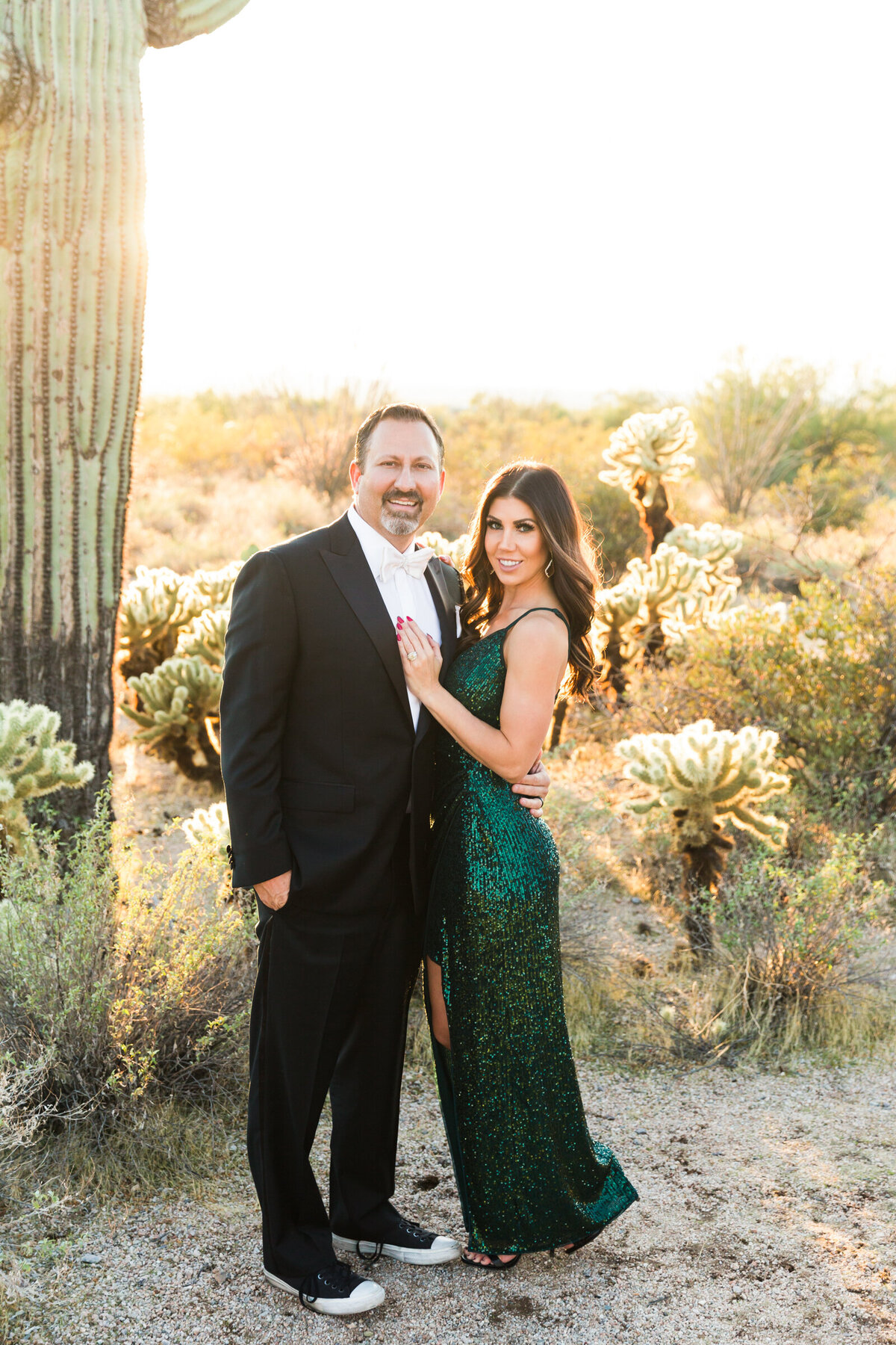 married couple styled in glam attire posing in the Scottsdale desert