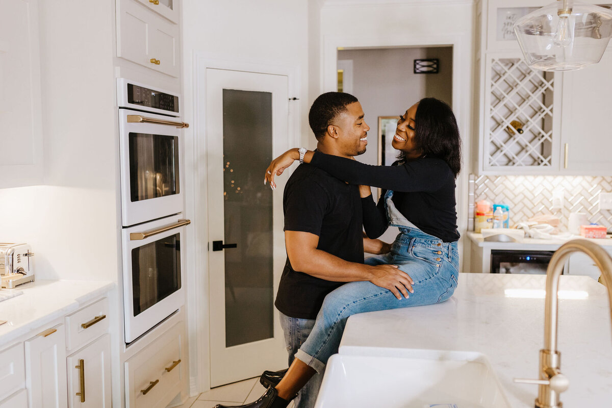 candid photo of husband and wife in kitchen during in home Longview, TX photography lifestyle session