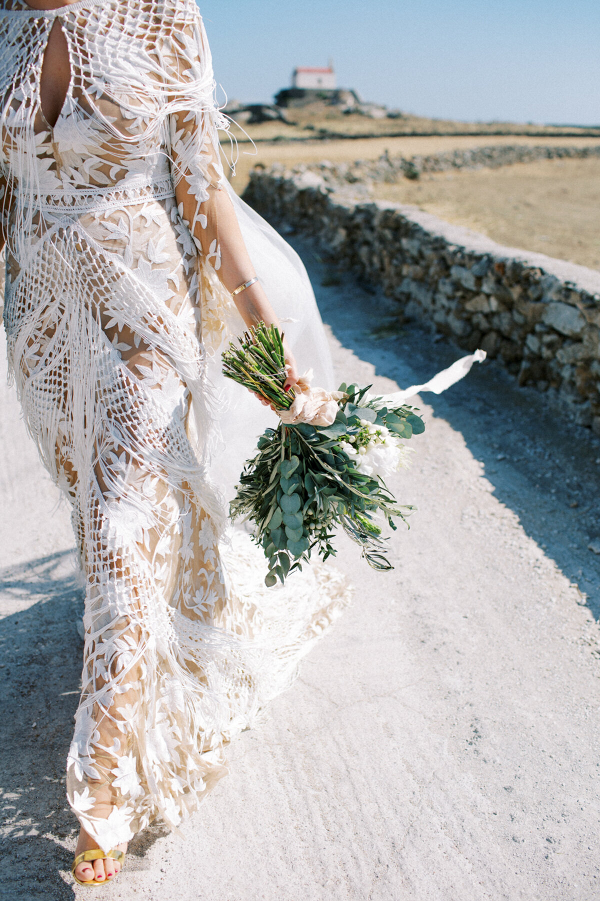 Bride carrying flowers on her wedding day in Mykonos