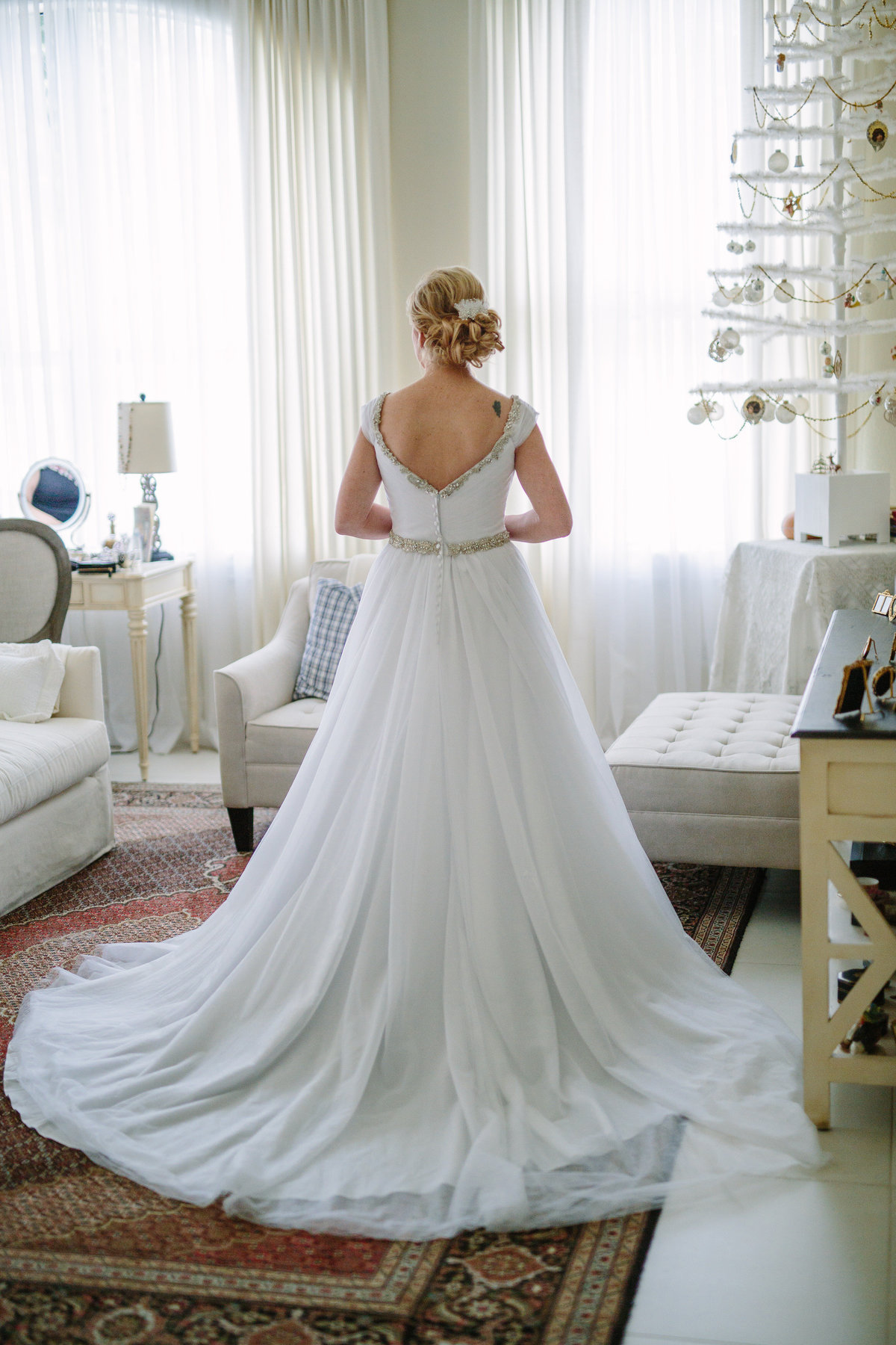 Back view of brides wedding gown after getting dressed for wedding ceremony.