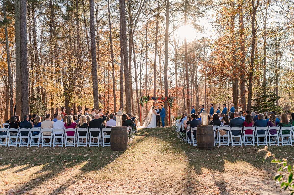 A fall wedding ceremony at Daniels Ridge at sunset by JoLynn Photography, a Raleigh wedding photographer