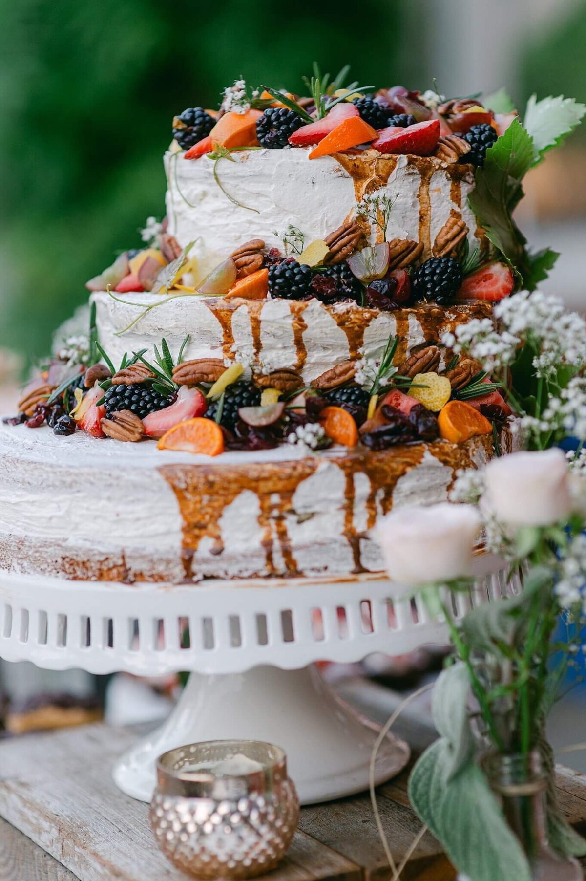 wedding cake with cream and fruits dripping
