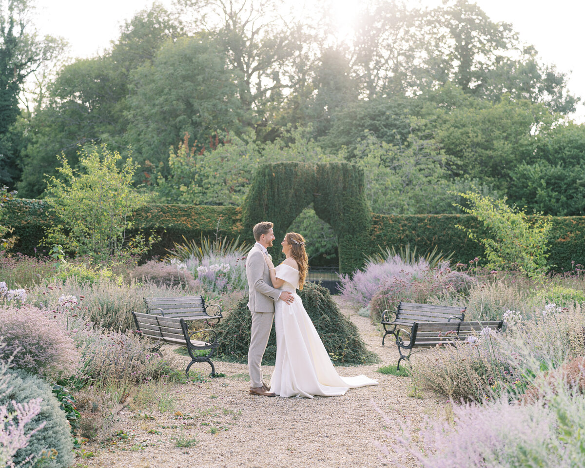 Bride and groom in the secret garden at Hampshire wedding venue Lainston House