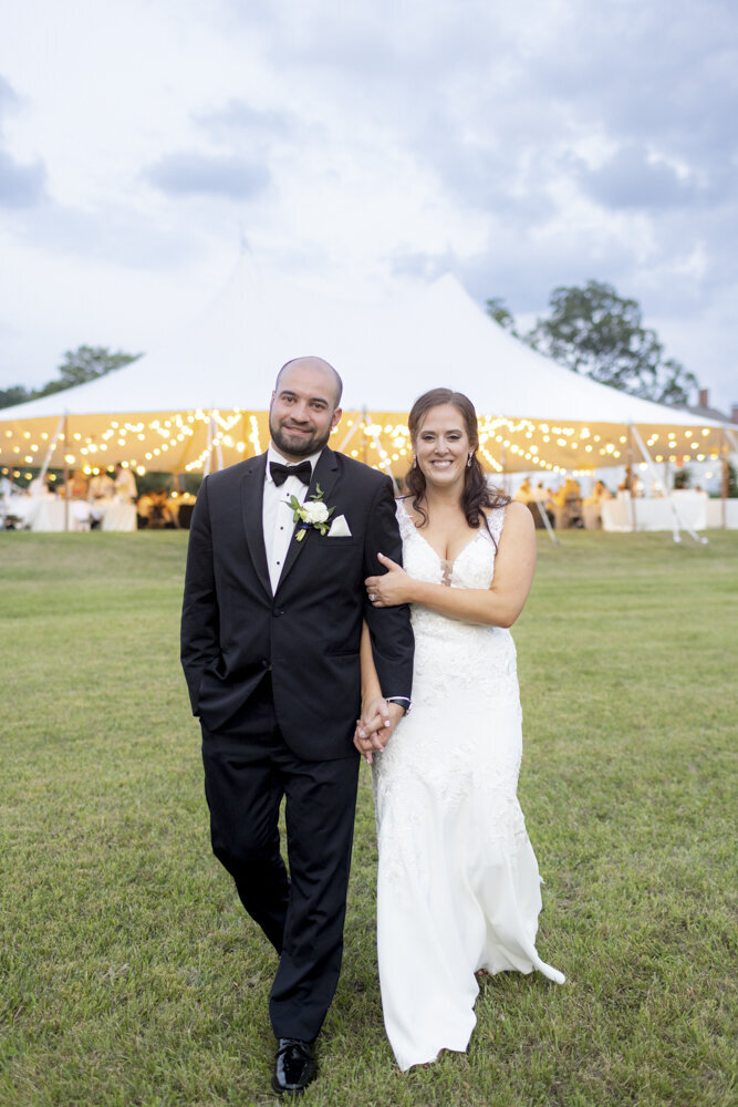 bride and groom pose outside of wedding reception tent - candlelight farms inn wedding