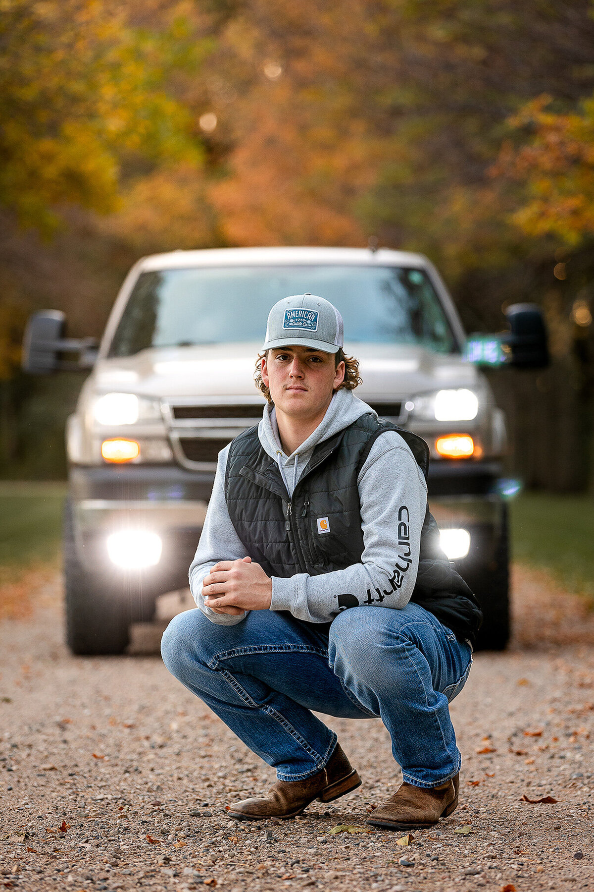 Senior posing in front of his truck for his high school picture session with Jennifer Brandes Photography.