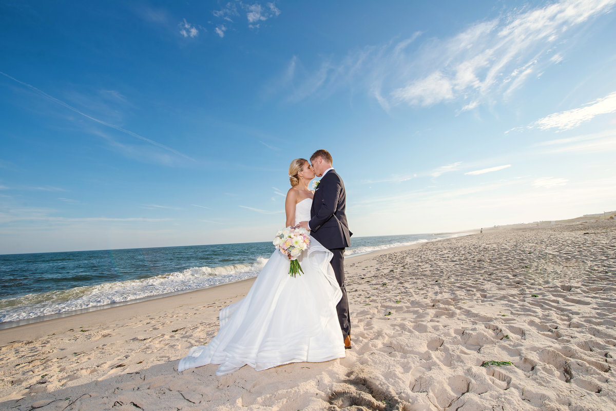 Bride and groom kissing on the beach