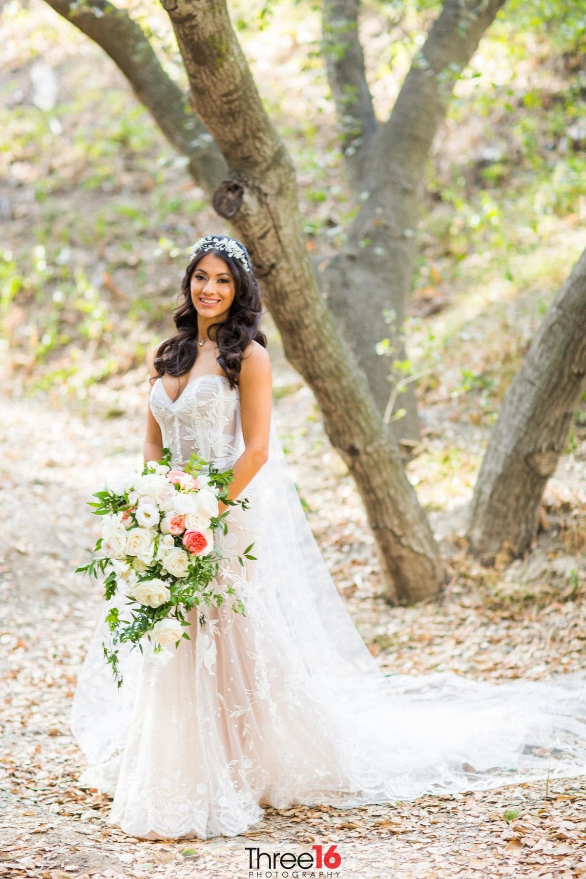 Gorgeous Bride poses for the wedding photographer under the trees