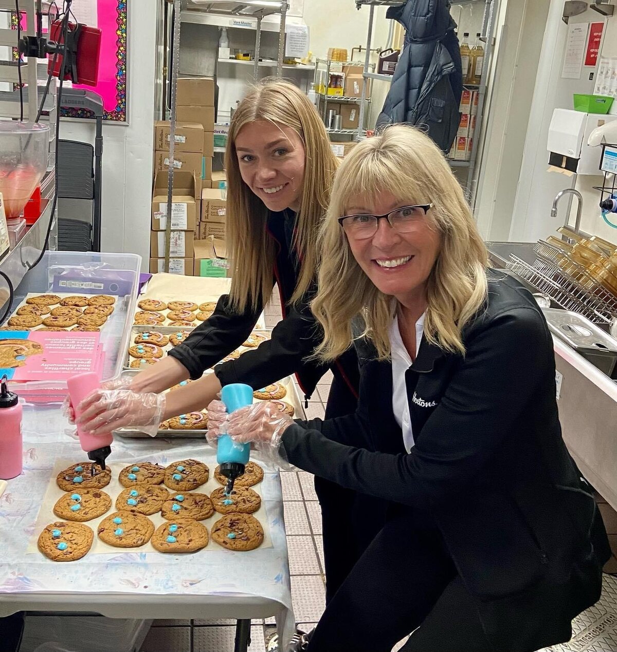 Owners decorating cookies during the Smile Cookie campaign