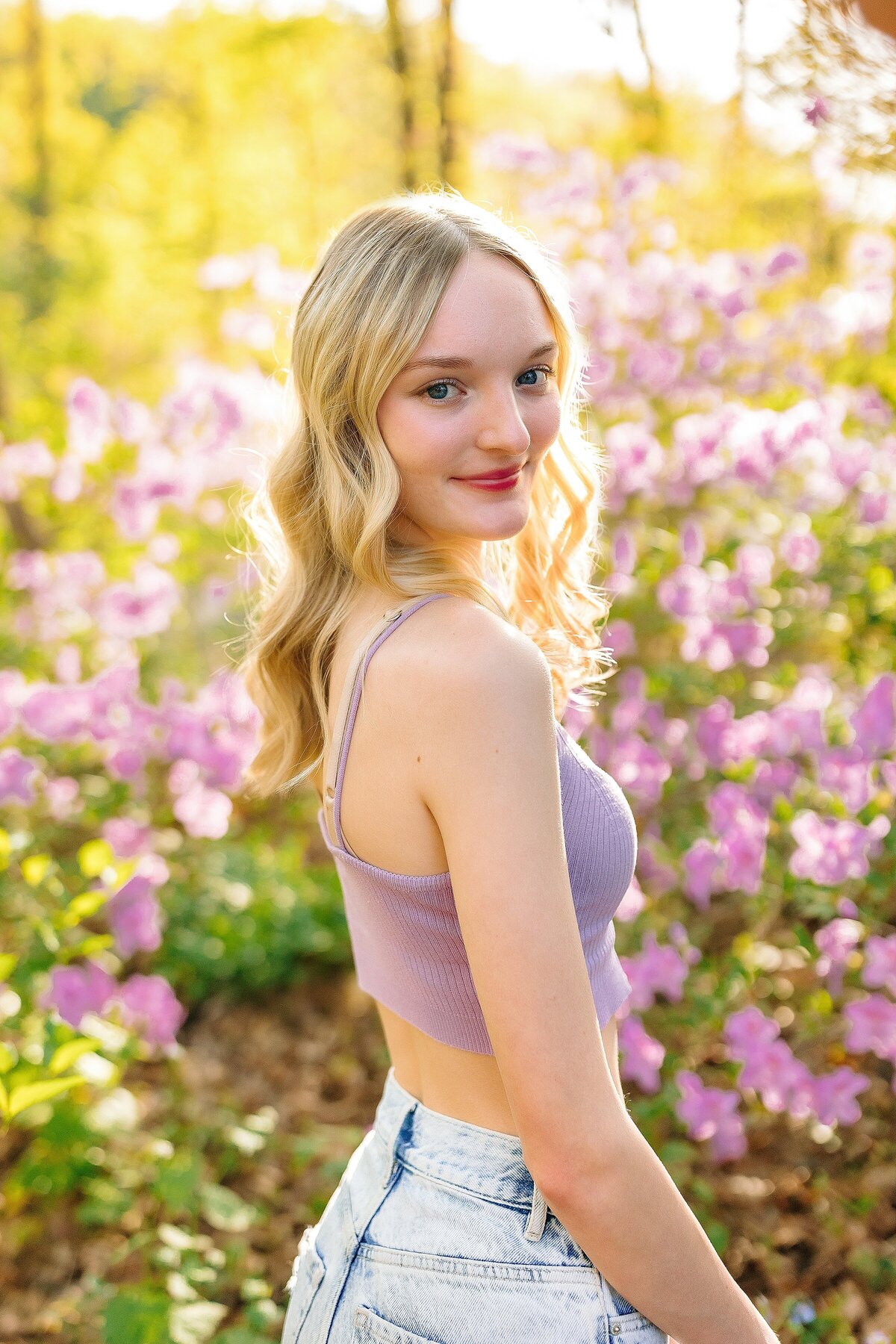 Senior in purple flowers at the JMU Arboretum