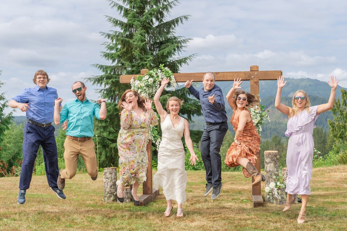 Bride and wedding party jumping in the air . Big Sur Wedding Photographer. Candid photo by 4Karma Studio