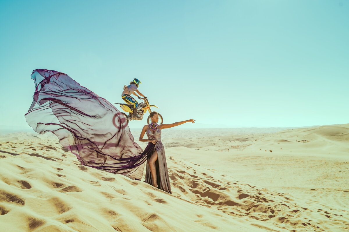 Black woman in desert with motorbike