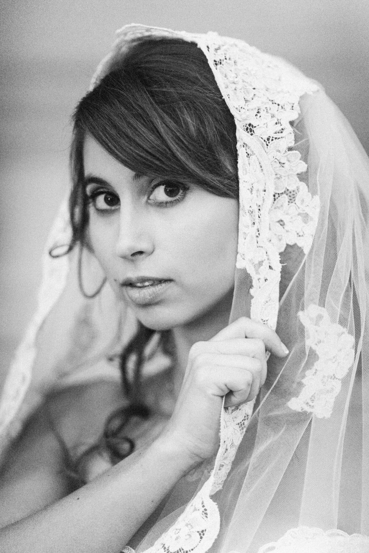 A bride holding her veil with one hand