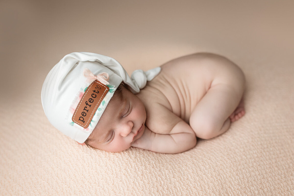Sleeping newborn with  hat.