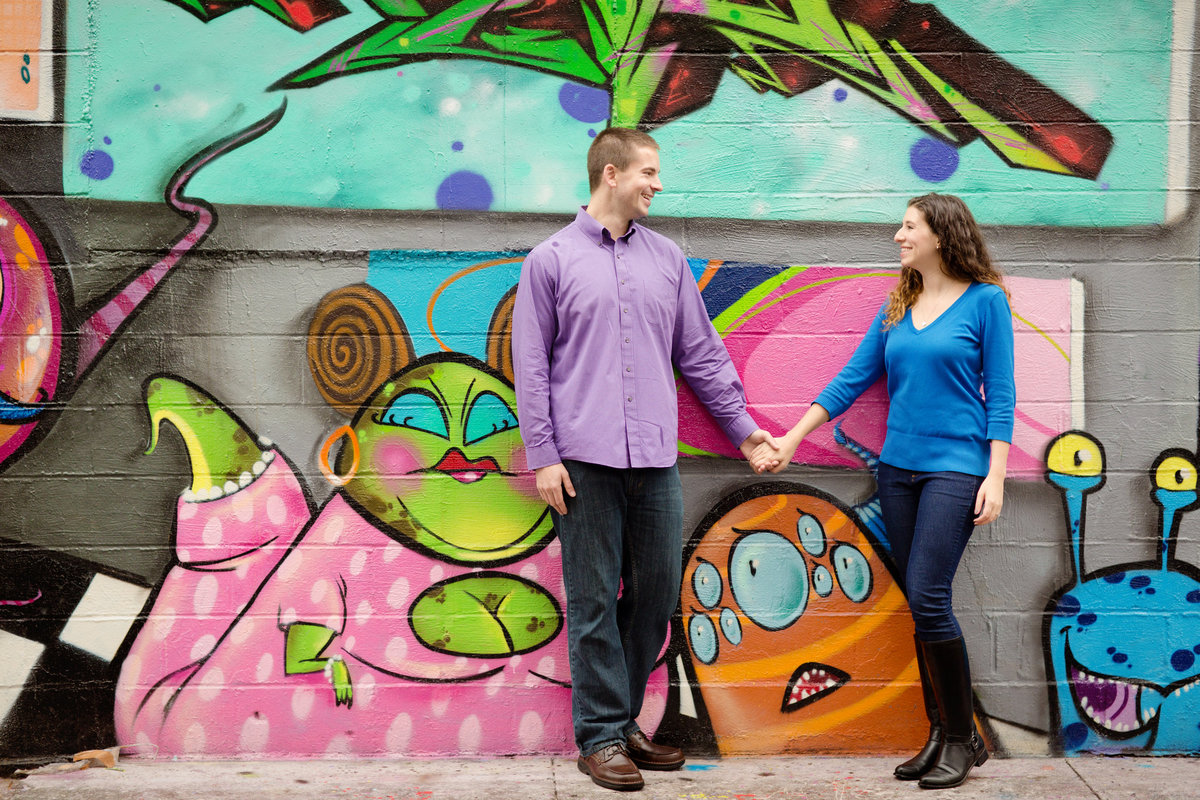 Couple in front of graffiti wall