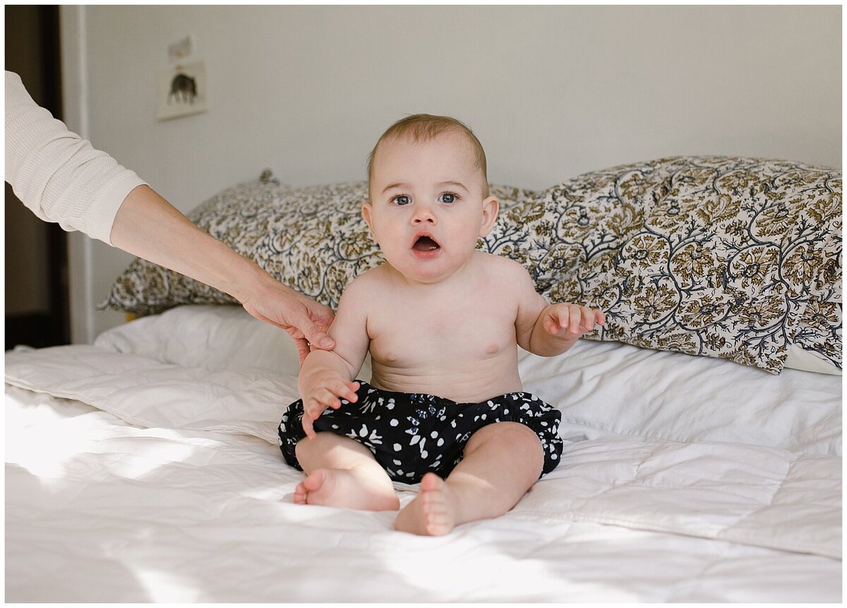 Baby sitting on bed at sweet home family session in Austin by Amber Vickey Photography