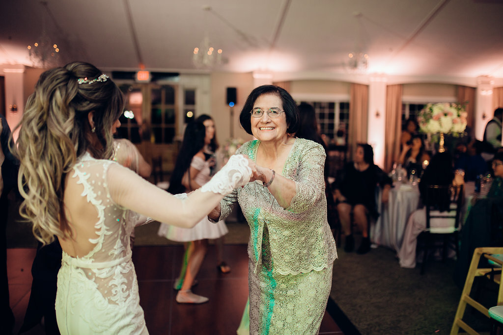 Wedding Photograph Of Bride In White Dress Dancing With An Older Woman Los Angeles