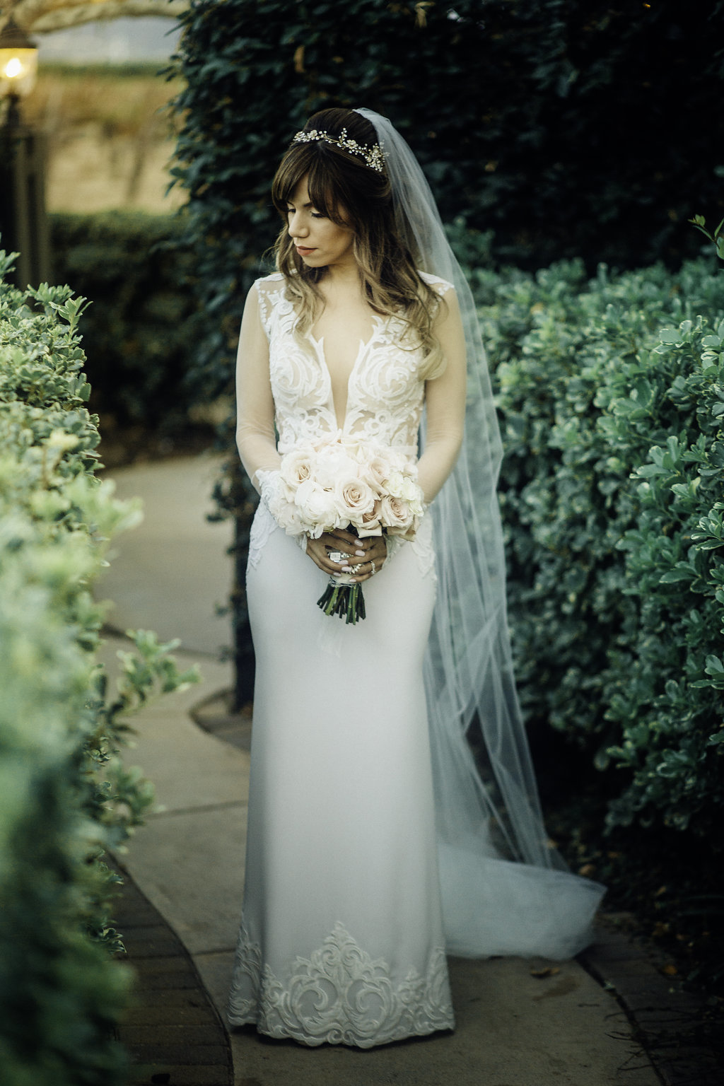 Wedding Photograph Of Bride Standing While Carrying a Bouquet in The Garden Los Angeles