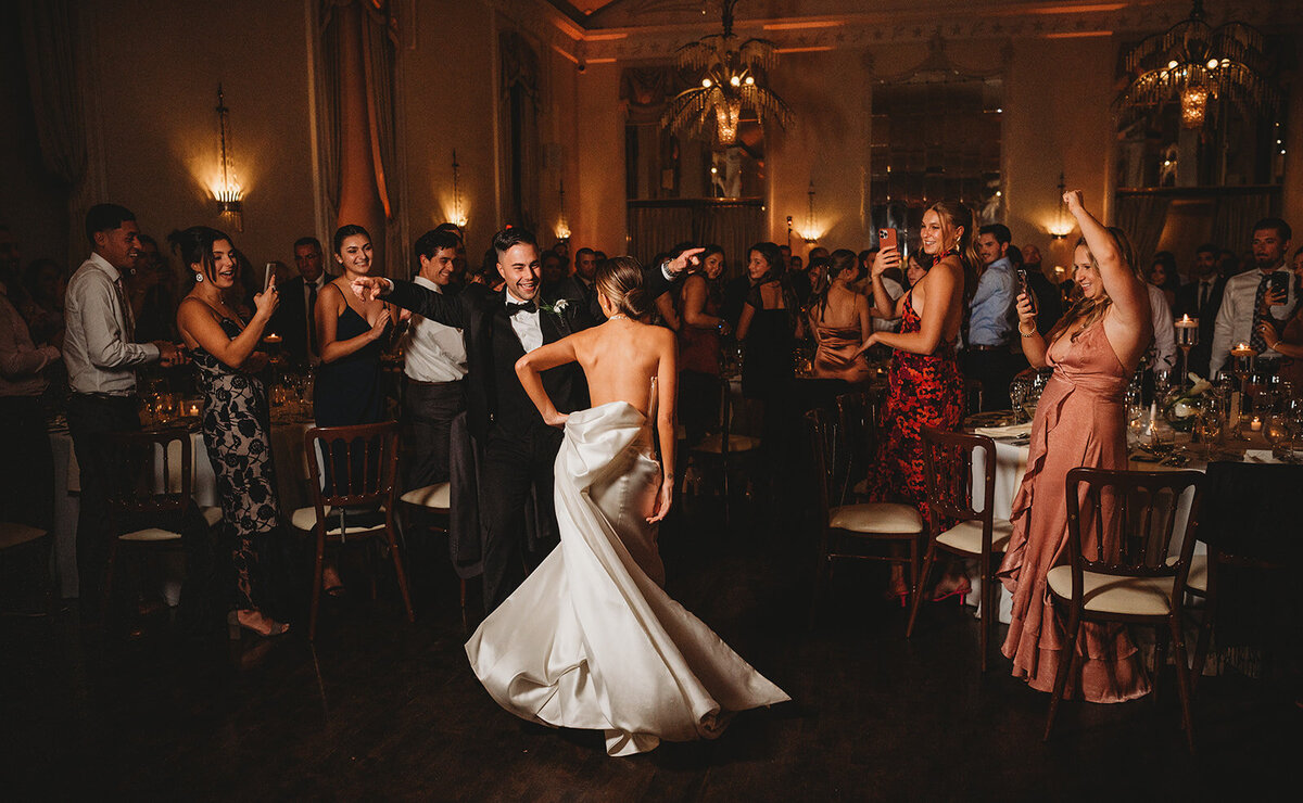 bride and groom make their grand entrance surrounded by their guests at new haven lawn club wedding photo by cait fletcher photography