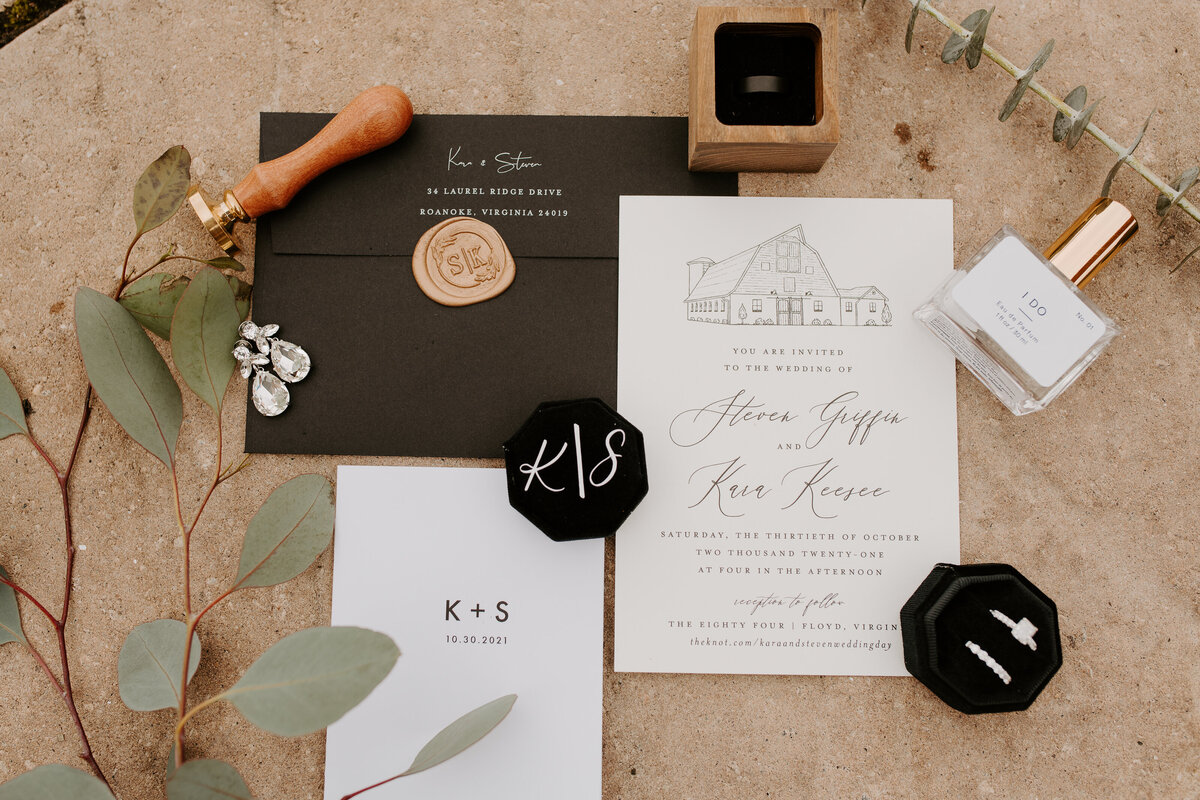 Invitations and ring shot of an intimate wedding in Virginia. Black and gold color palette wedding inspiration.