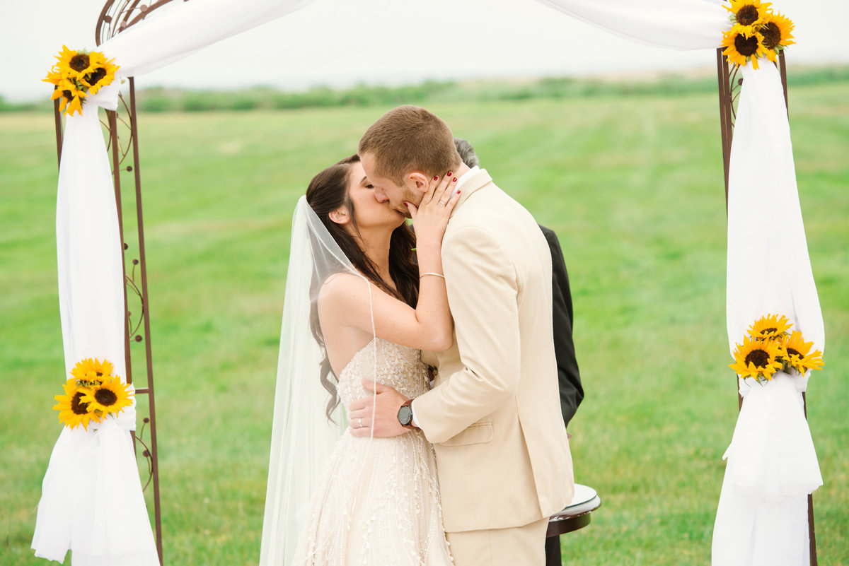 Bride and groom's first kiss at The Bourne Mansion