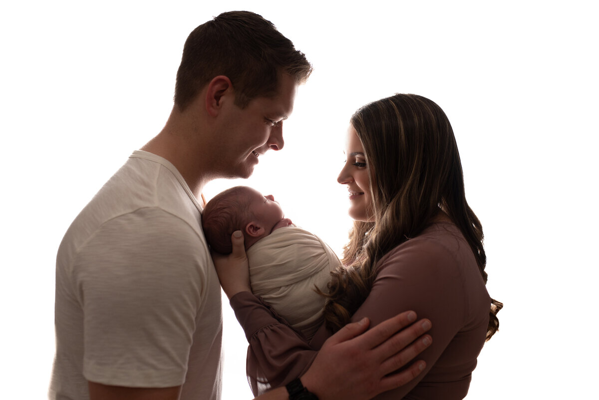 silhouette image of mom dad and newborn baby at atlanta newborn photography portrait studio