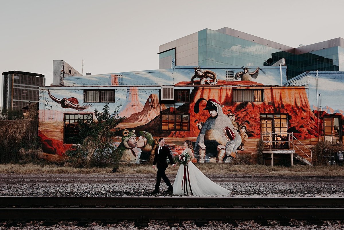 Bride and Groom elope and take photos along a mural and train tracks in Tucson Arizona