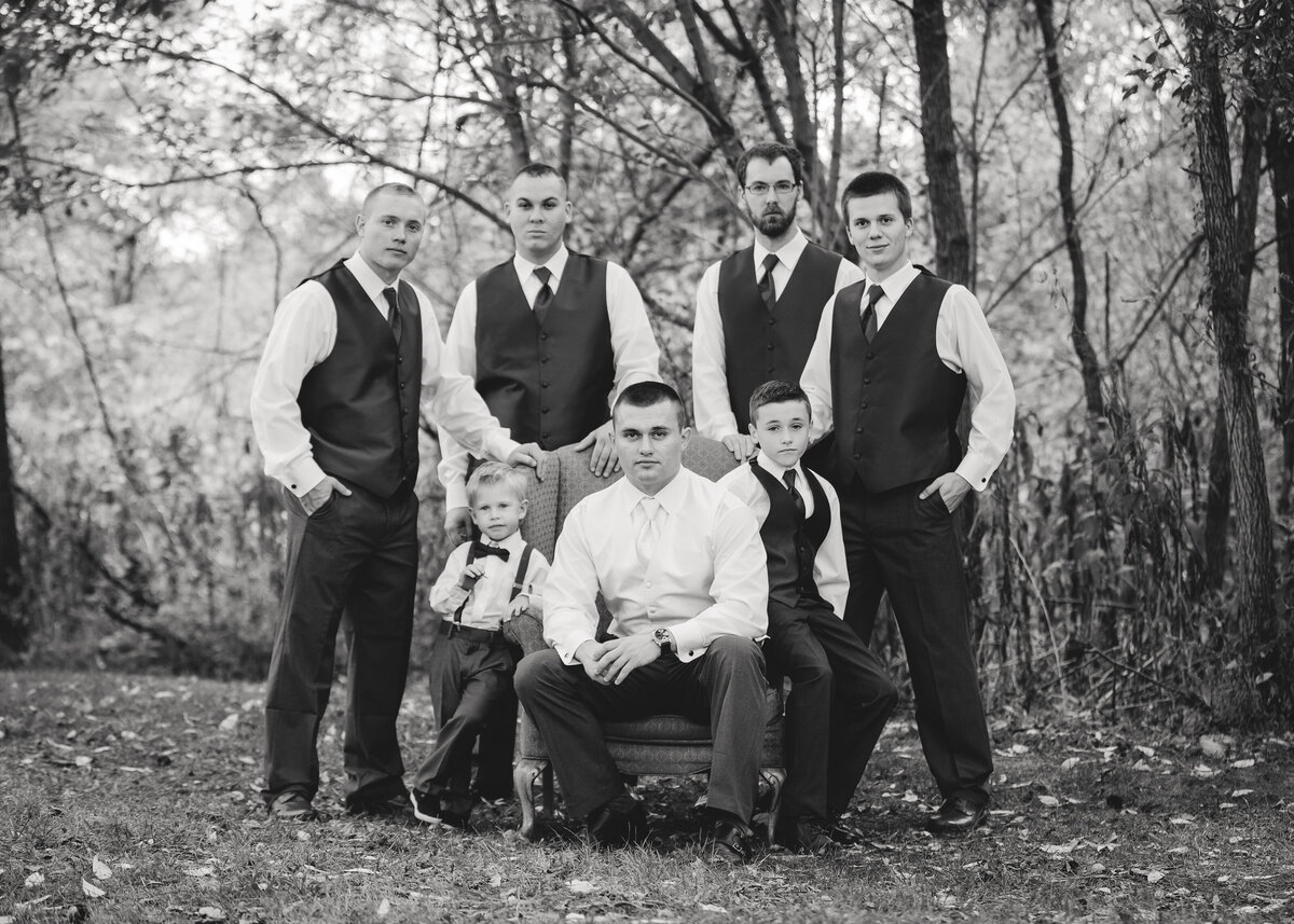 black and white image of groom with groomsmen and ring bearers