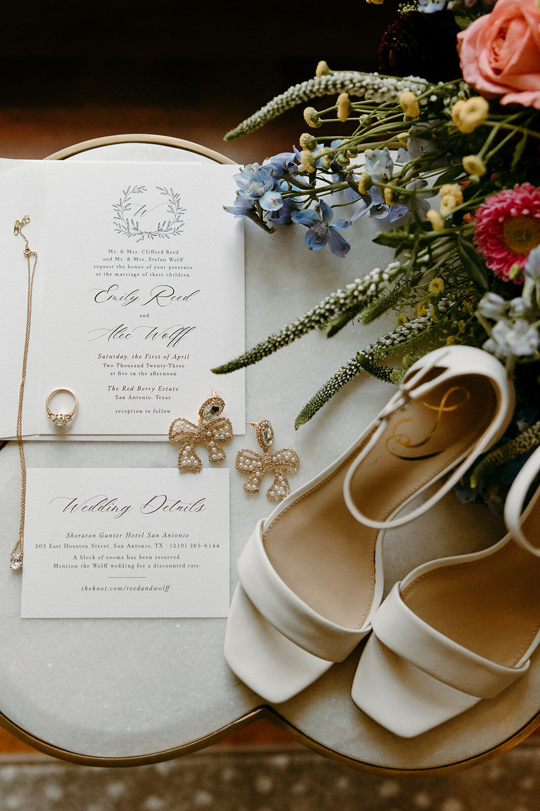 wedding detail shot of invitations, wedding shoes, and jewelry