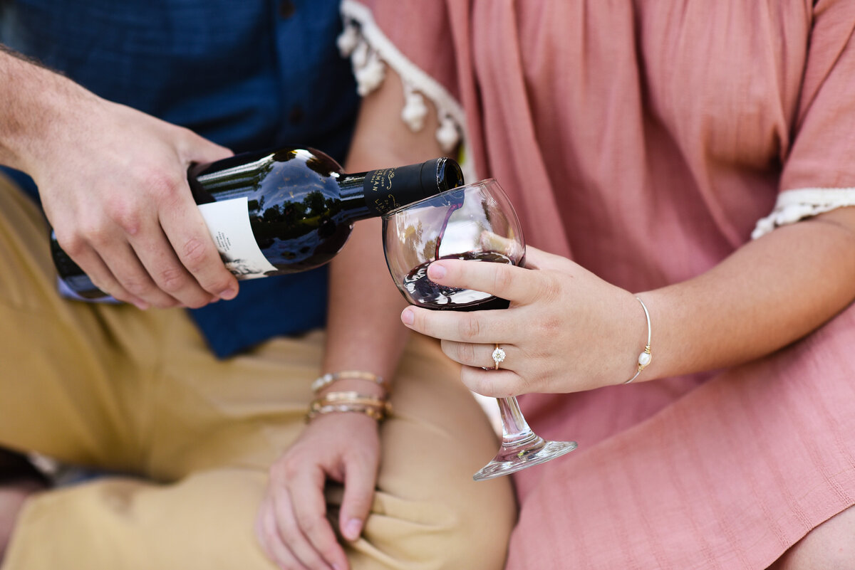 Beautiful Mississippi Engagement Photography: couple enjoys wine at engagement picnic in Mississippi