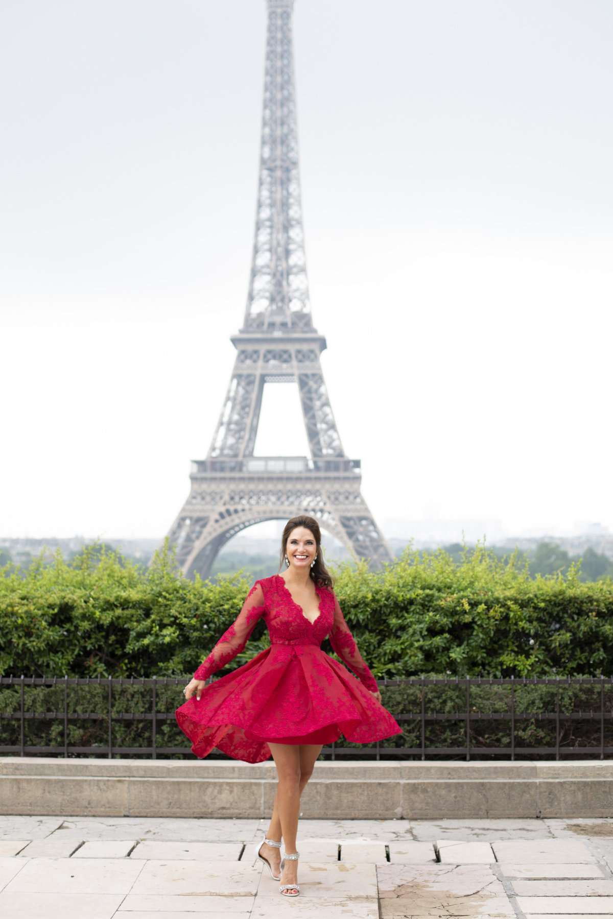 Beautiful woman in red dress spins in front of Eiffel Tower 49