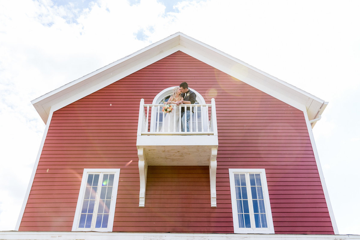 barns of old glory balcony bride and groom