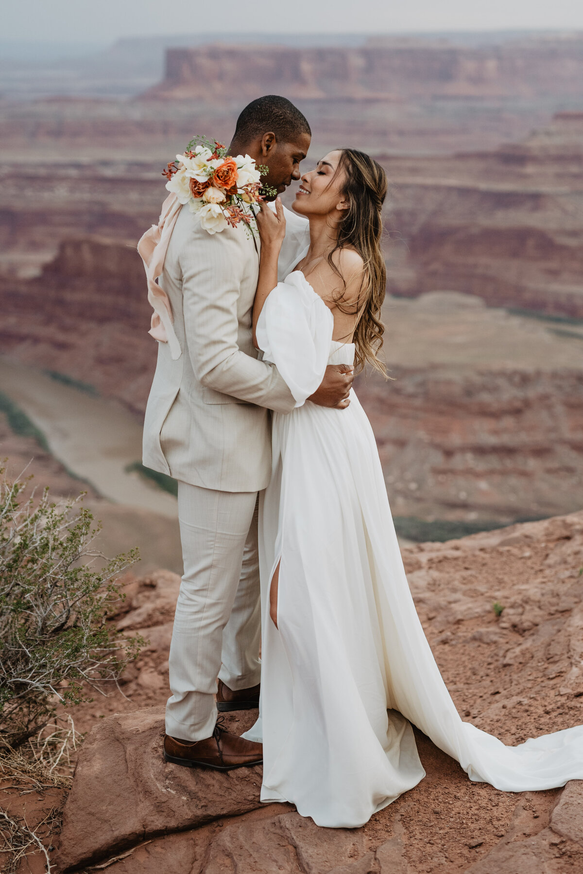 Utah Elopement Photographer captures couple kissing on red rocks