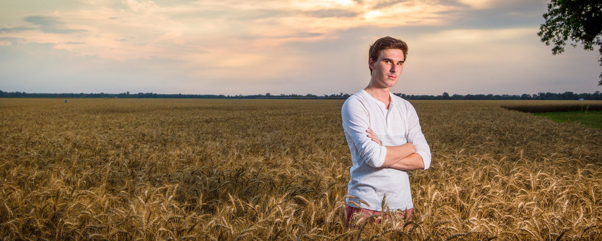 Senior photo of Garrett Roxbury in Atmore, Alabama wheat field.