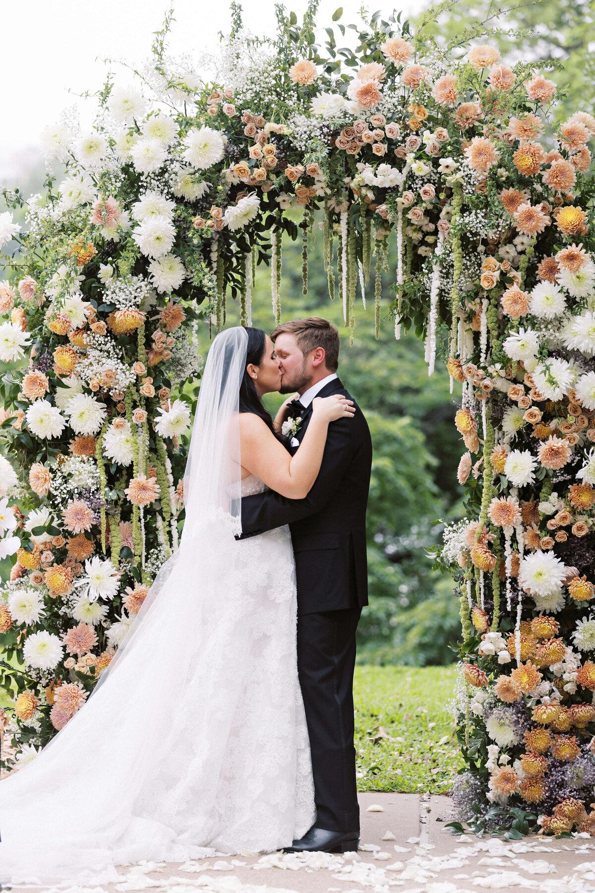 colorful spring wedding ceremony arch by Stems Floral Designs
