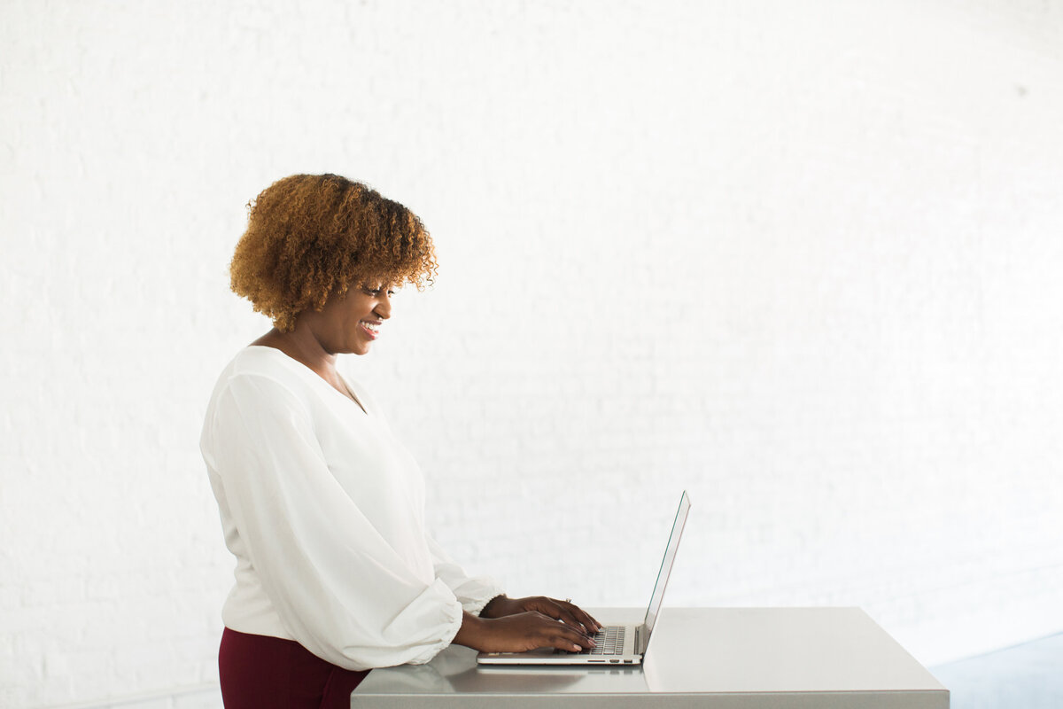 black woman typing white background