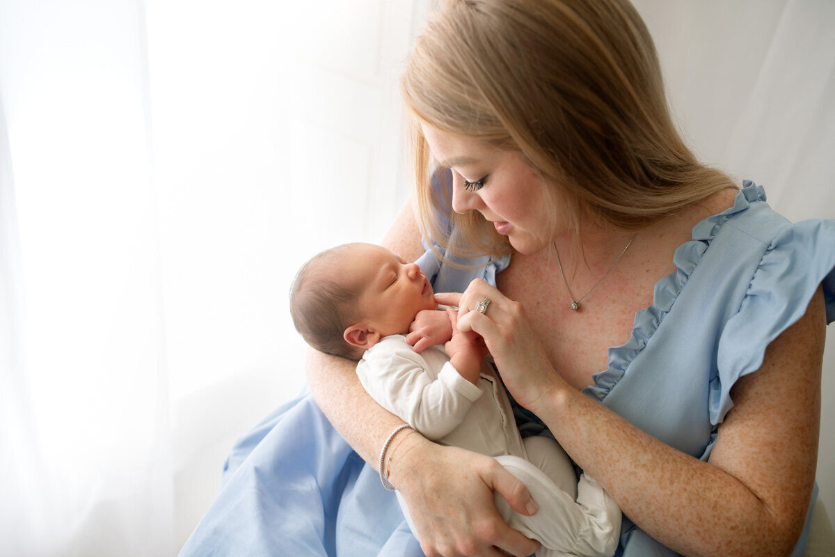 Newborn session of baby with mother wearing a blue dress