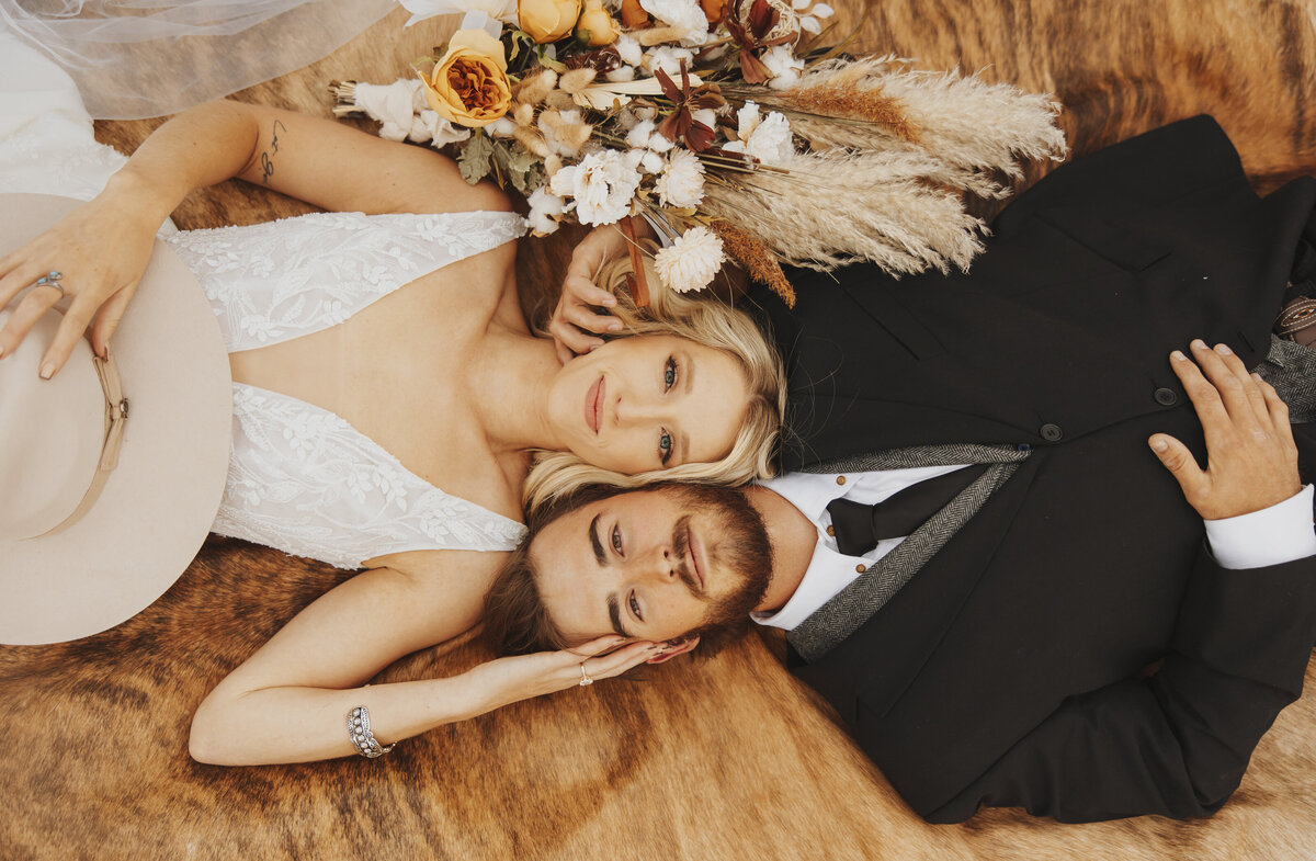 bride and groom laying on floor