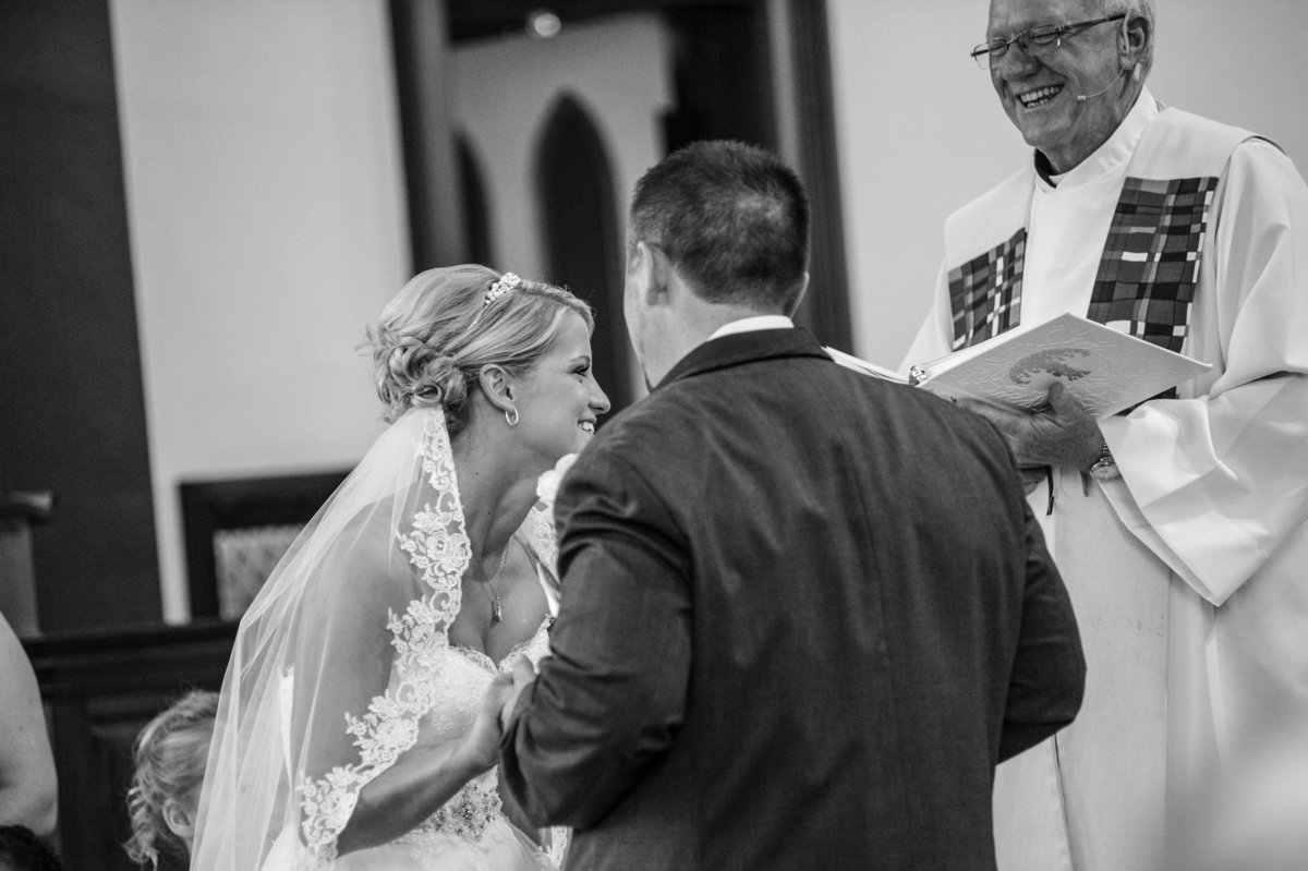 bride laughs during ceremony