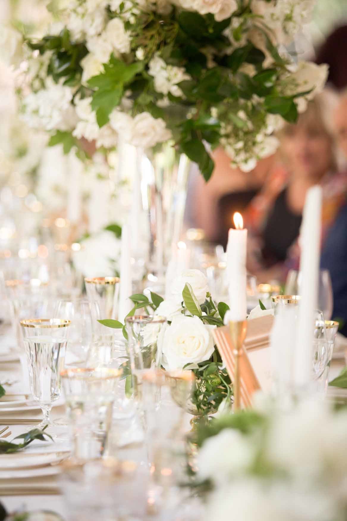 Tall garden style white and green arrangement with candles