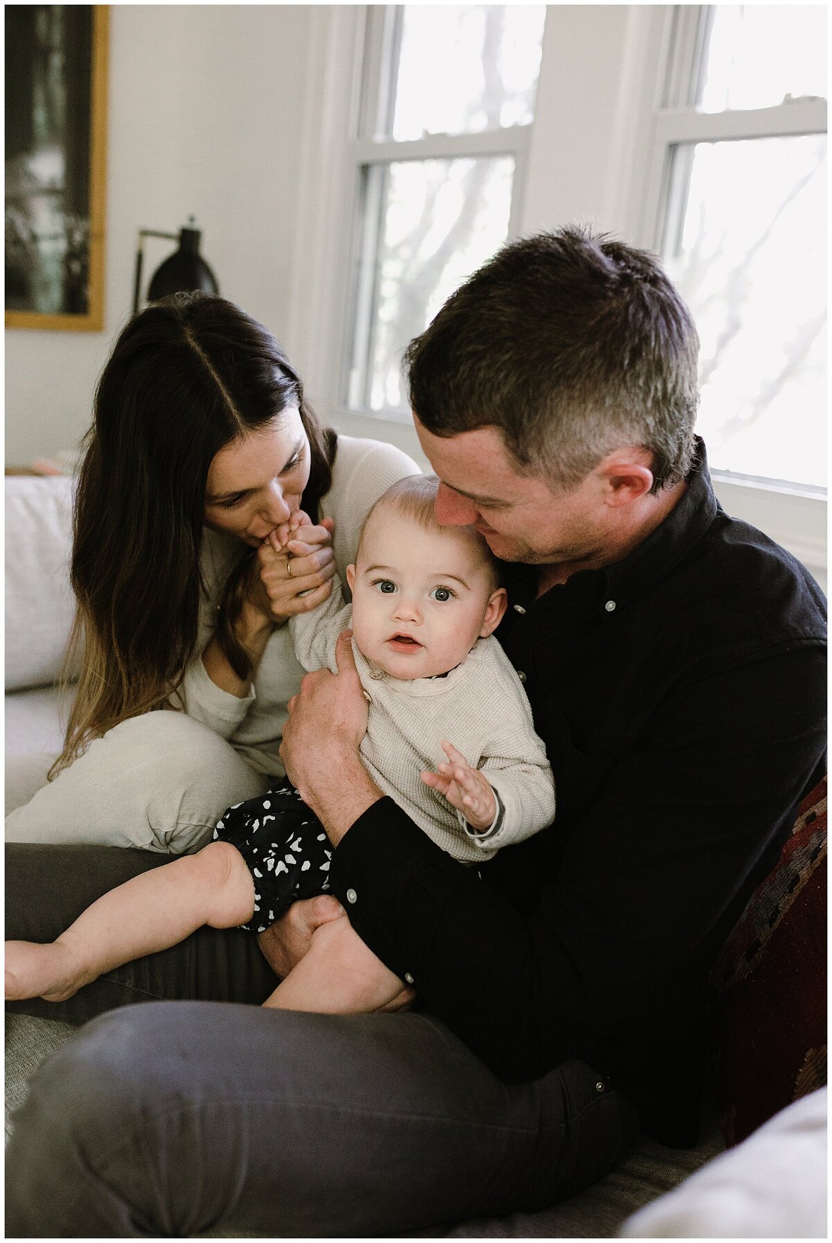 Mother and father with baby on their lap at sweet home family session in Austin by Amber Vickey Photography