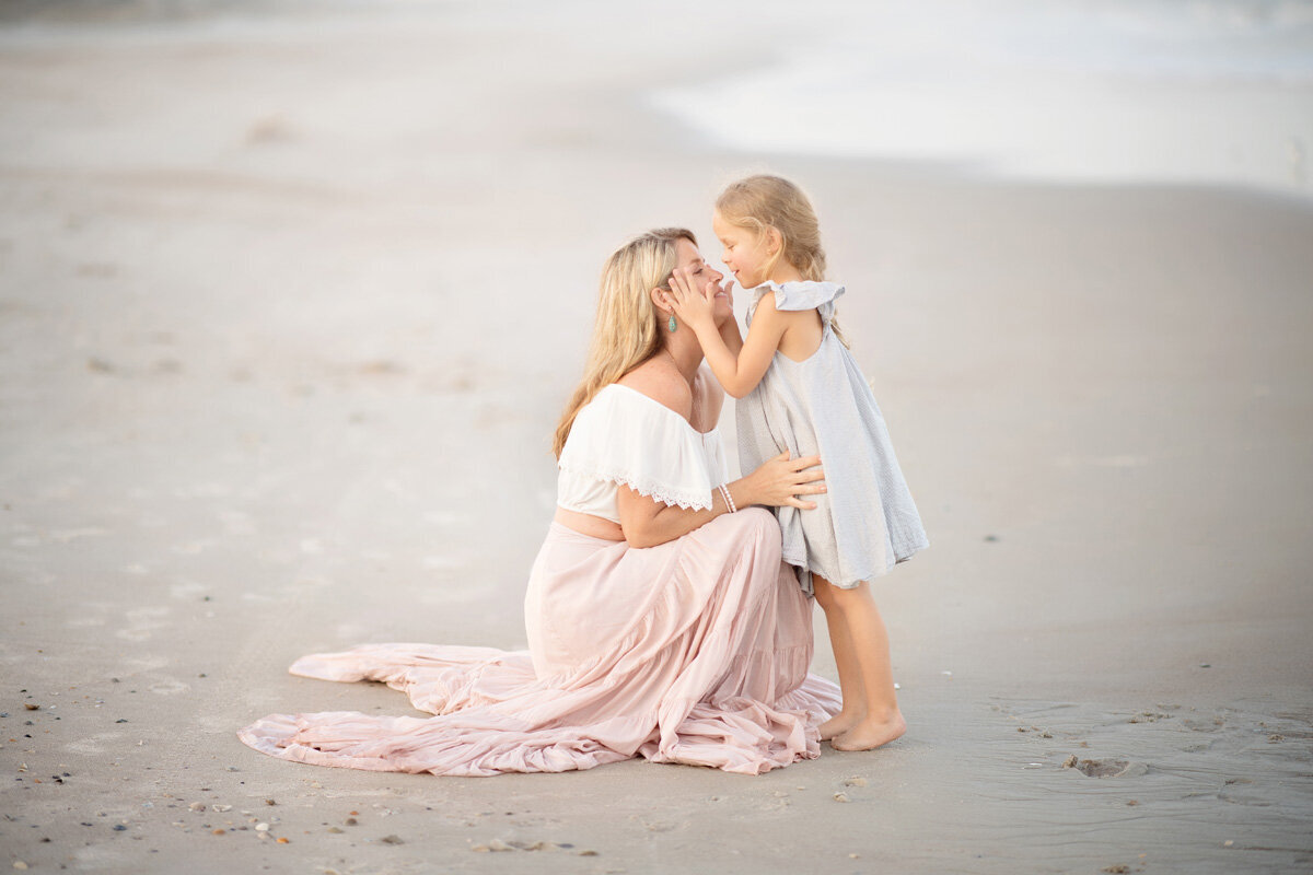 Family session of mother and daughter located at the beach