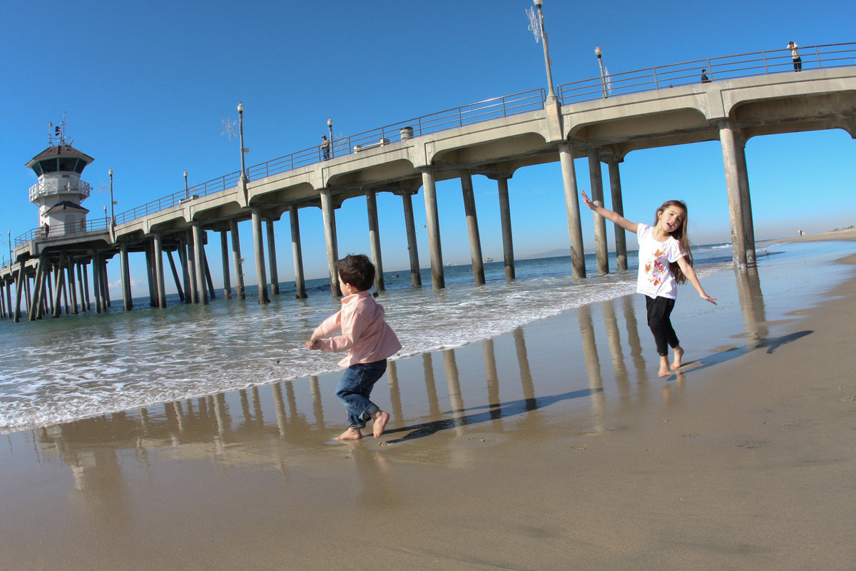 portrait of kids running on beach