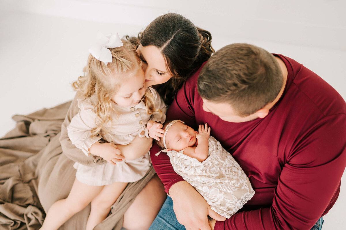 family with newborn baby girl captured by Springfield Mo newborn photographer The XO Photography