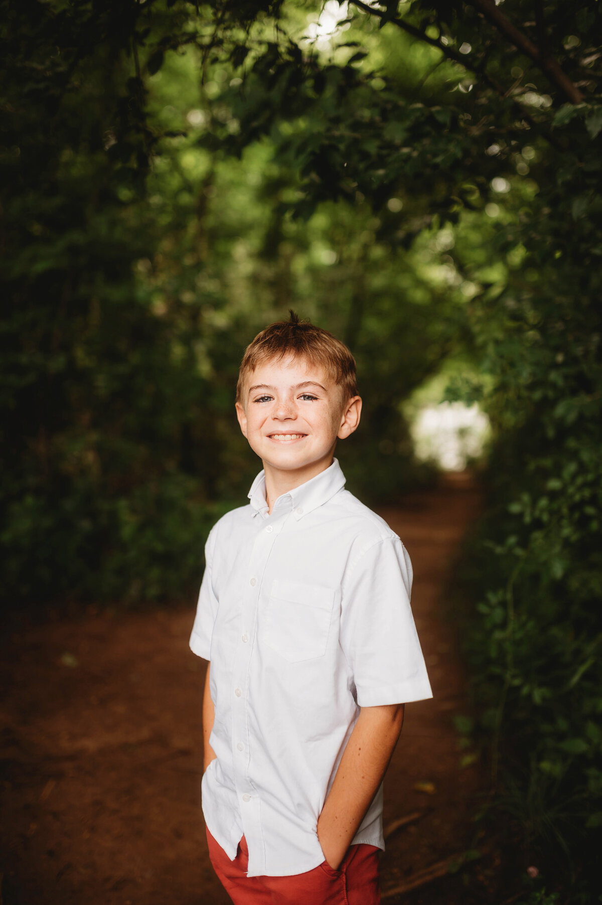 Child poses for Portraits during an Extended Family Photoshoot in Asheville, NC.