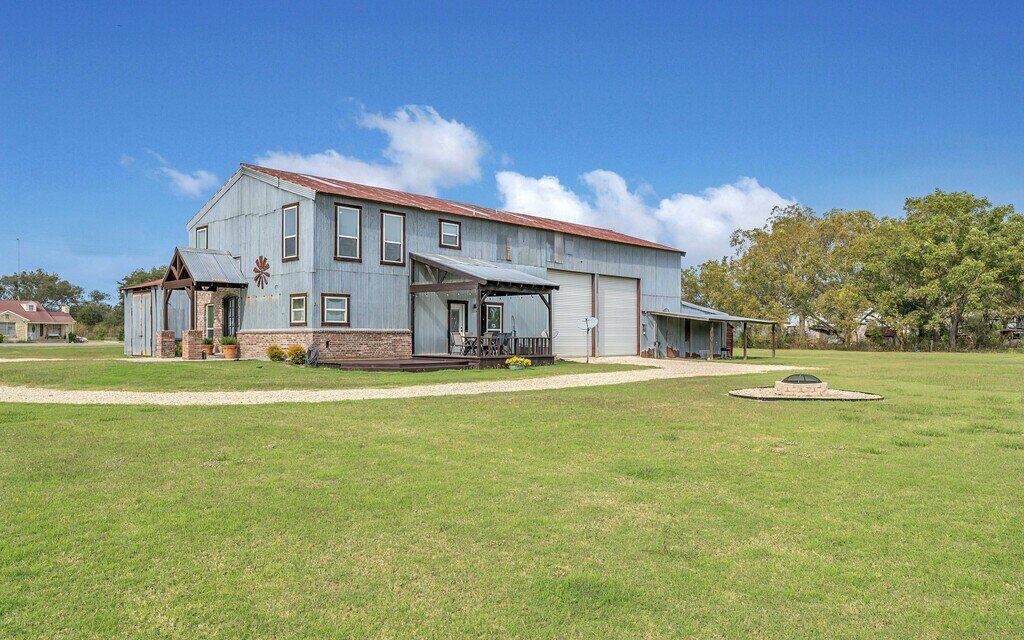 Exterior view of this four-bedroom, four-bathroom vacation rental home and guest house with free WiFi, fully equipped kitchen, firepit and room for 10 in Waco, TX.