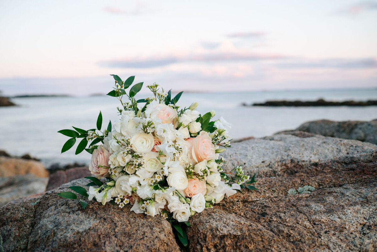 closeup of white and pink flower bouquet on rocks at misselwood wedding